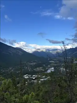 View of Banff town and the Bow River as visible from Tunnel Mountain in August 2024.