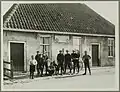 Local youth in front of a house (unknown date)