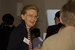 Pietilä chats with a fellow attendee at a conference