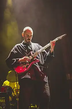 Will Archer plays guitar on stage