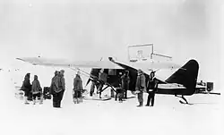 Wop May loads his airplane at Aklavik.