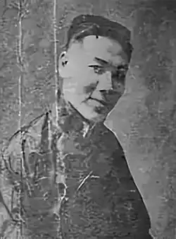 A black-and-white image of a smiling young man
