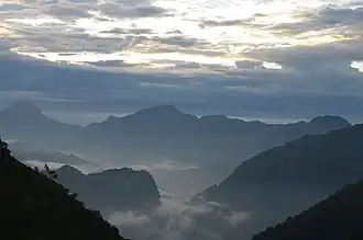 View of the rugged mountains of the Wa country with the valleys covered in mist.