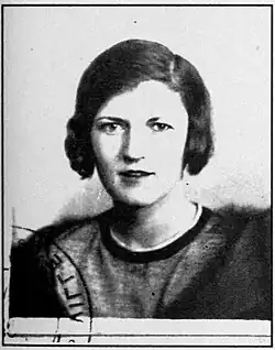 A black and white, heavily exposed photograph of an older Zelda Fitzgerald used for her French identity card. She is staring at the camera and appears slightly haggard. She has dark brown hair and has a rather distant gaze.