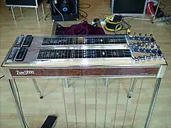 A pedal steel guitar, with the word "Zumsteel" written on its side.