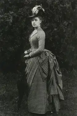 Black and white full-length portrait of Austen, looking at the viewer at a 3/4 angle